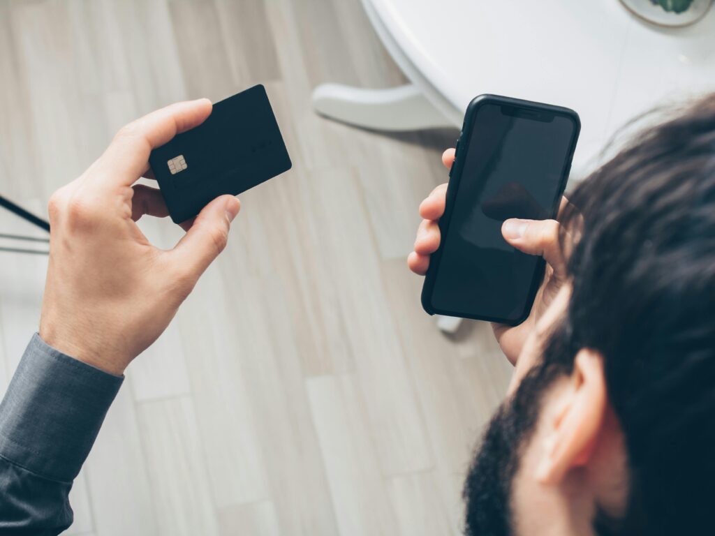 Man in Black Long Sleeve Shirt Holding Black Mobile Phone